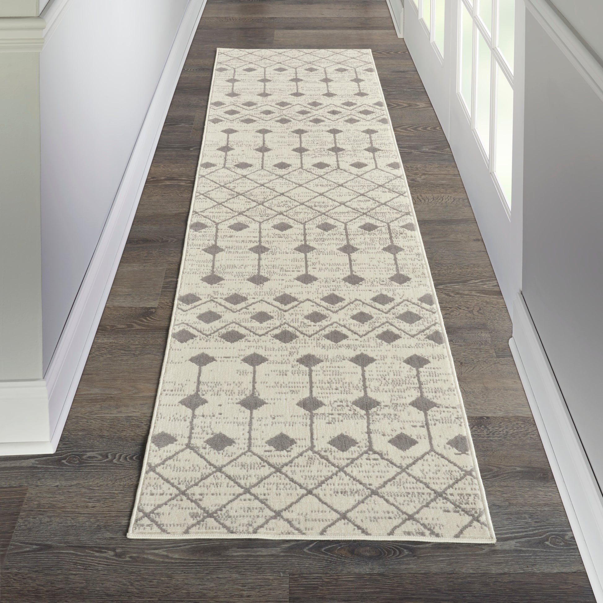 Ivory hallway runner rug with gray geometric diamonds and trellis pattern; neutral woven design for entryways.
