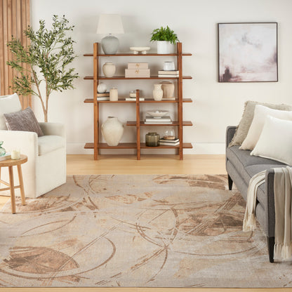 Cozy living room with a tall wood open bookshelf, ceramic vases, books, a plant, beige area rug, and beige/gray sofas.