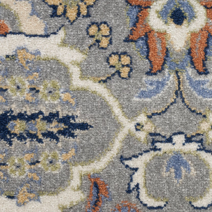 Close-up of a gray oriental rug with blue, ivory & rust floral motifs and curling vines.