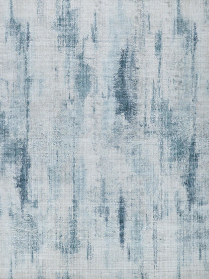 Abstract blue-gray area rug with vertical brushstroke pattern; cool denim tones, modern decor accent.