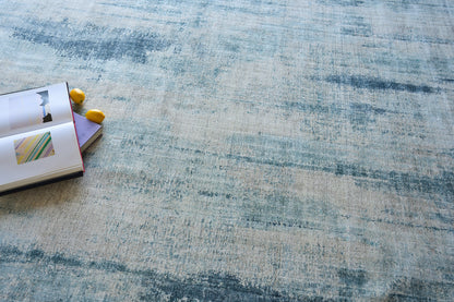 Open notebook with colorful page inserts and yellow pencils on a blue textured rug.
