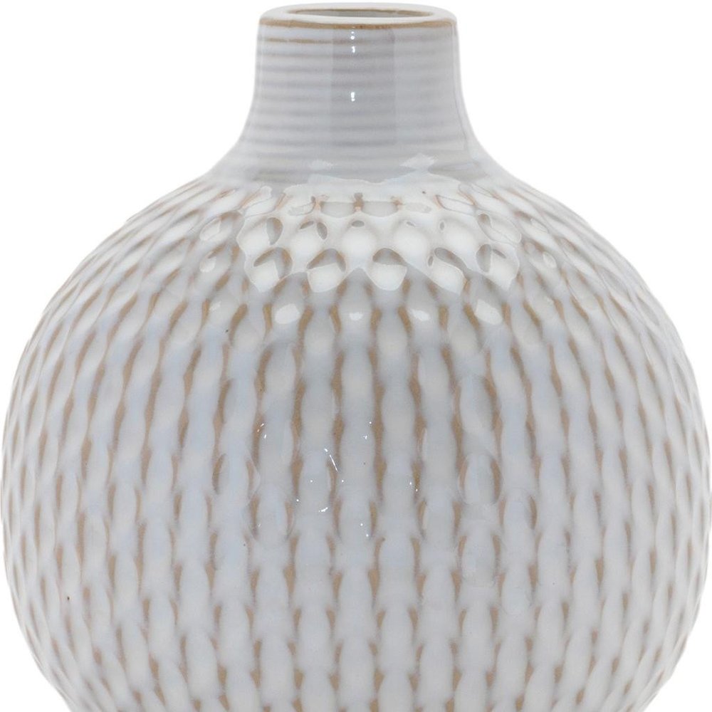 Set of four natural and off-white ceramic bud vases with sculptural details.