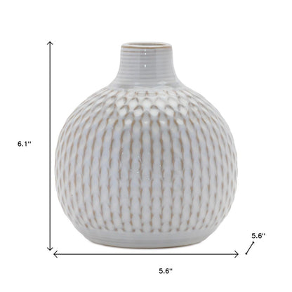 Set of four natural and off-white ceramic bud vases with sculptural details.