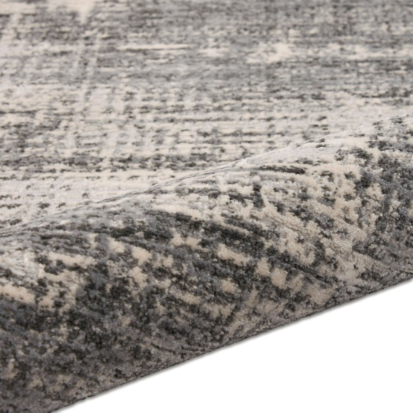 Gray and ivory distressed patterned rug with plush, soft pile.