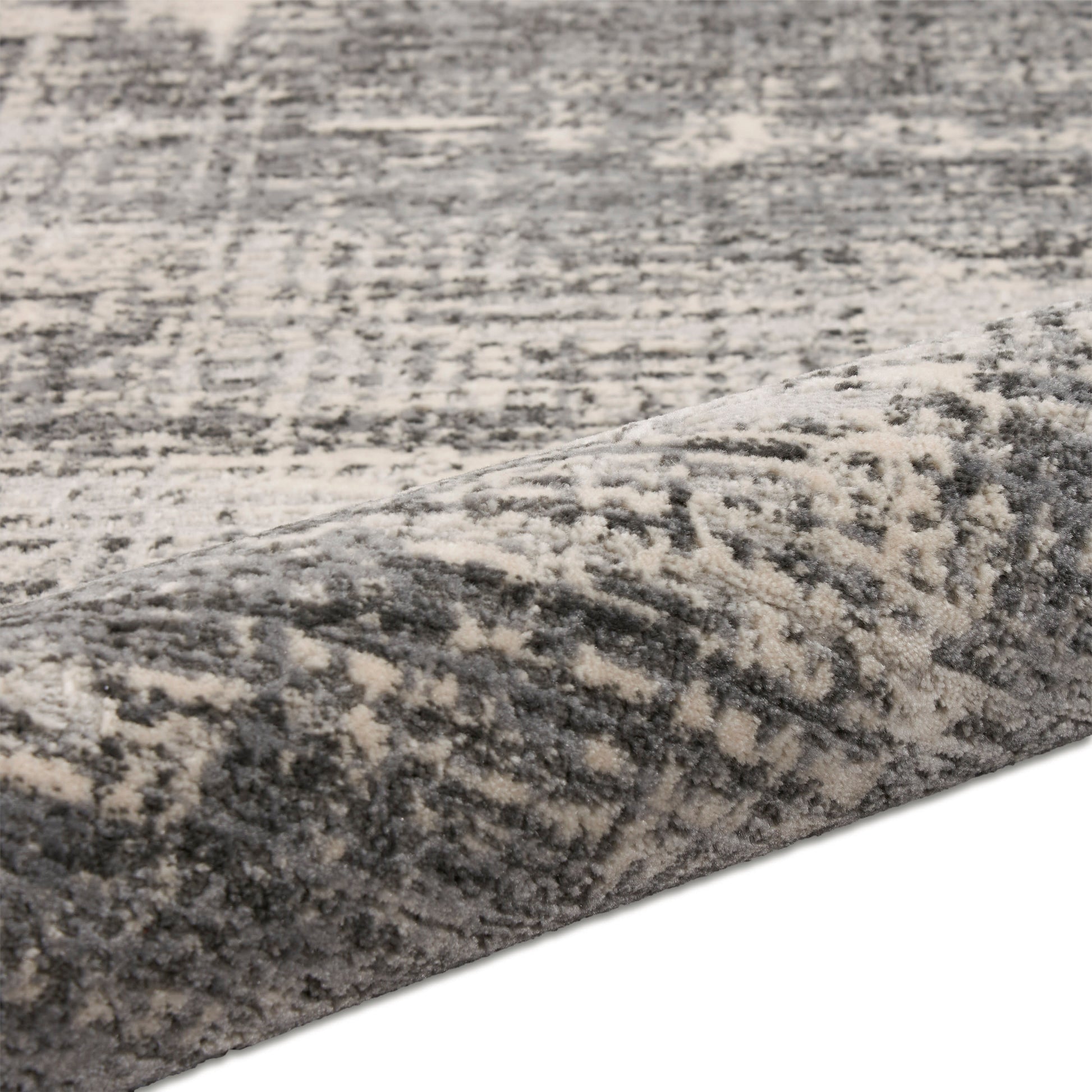 Gray and ivory distressed patterned rug with plush, soft pile.