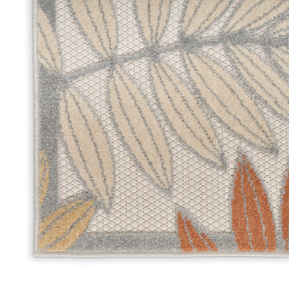 Textured area rug with beige, gray and orange leaf pattern, loop pile, ivory background and gray border.