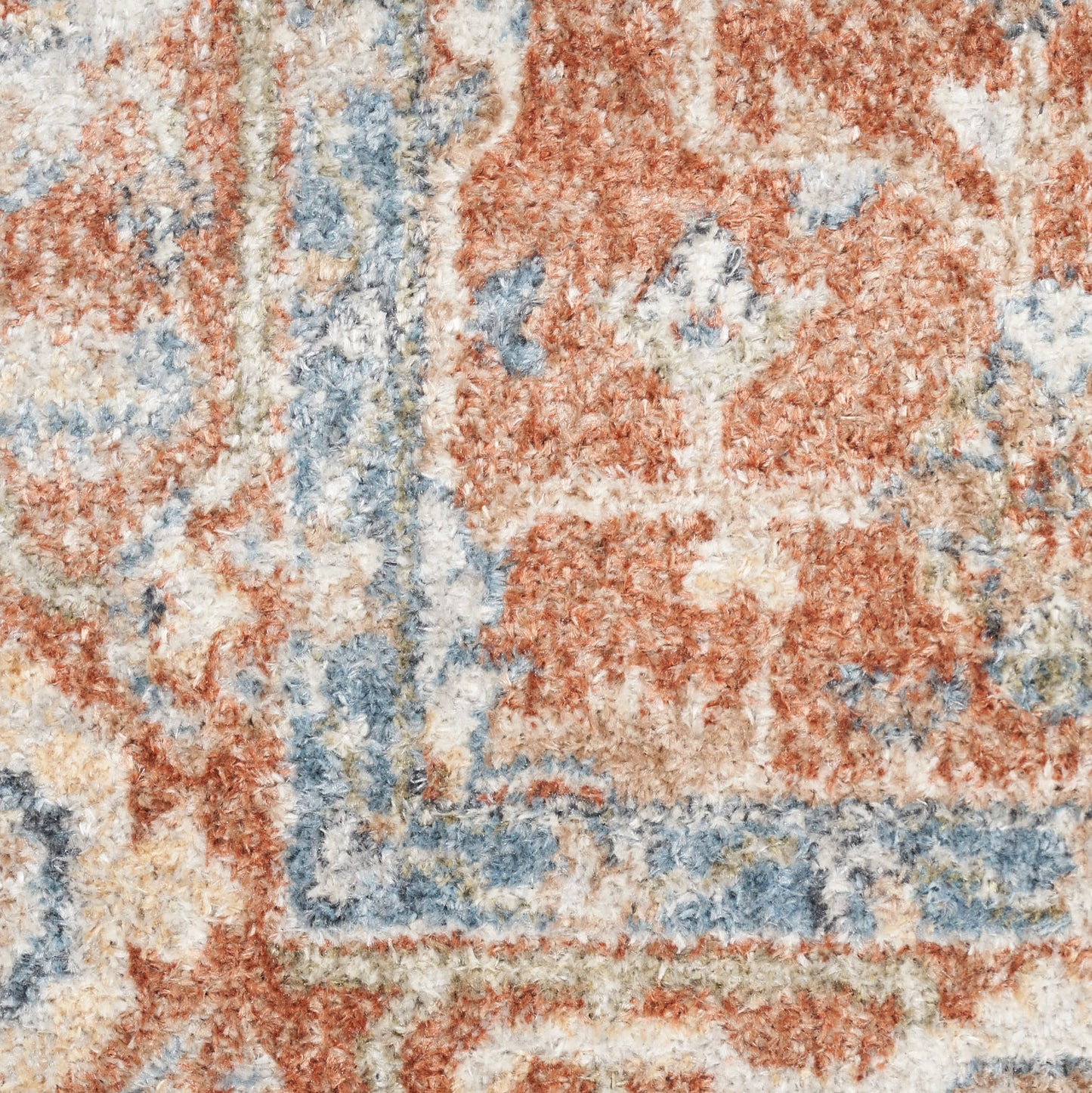 Close-up of a plush rug with red, blue & ivory oriental floral pattern.