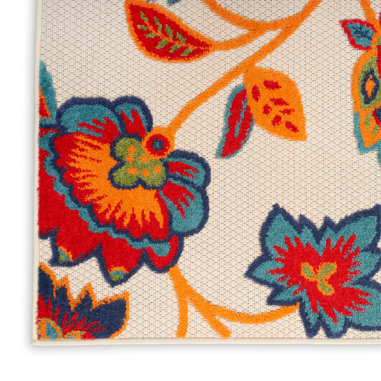 Beige woven rug featuring a bold multicolor floral pattern in orange, teal, red and yellow.