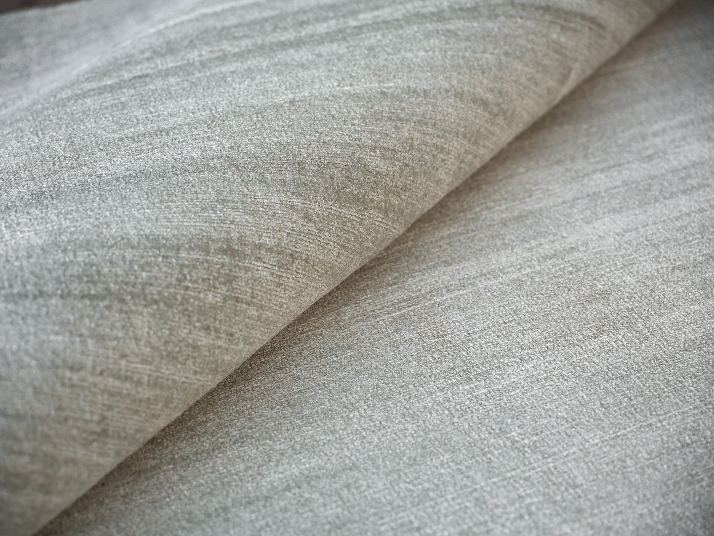 Gray heathered woven fabric with soft drape and subtle texture; upholstery for sofas or cushions.