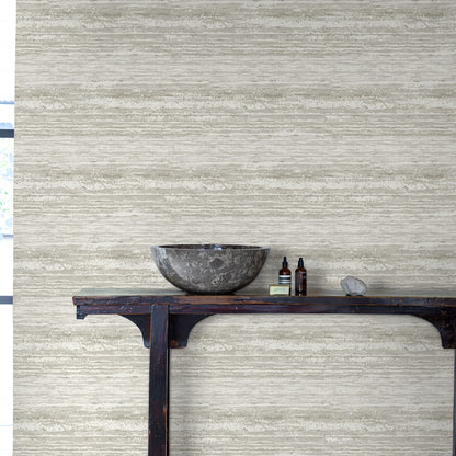 Wallpaper with a pewter-toned desert-horizon pattern on a beige textured wall.
