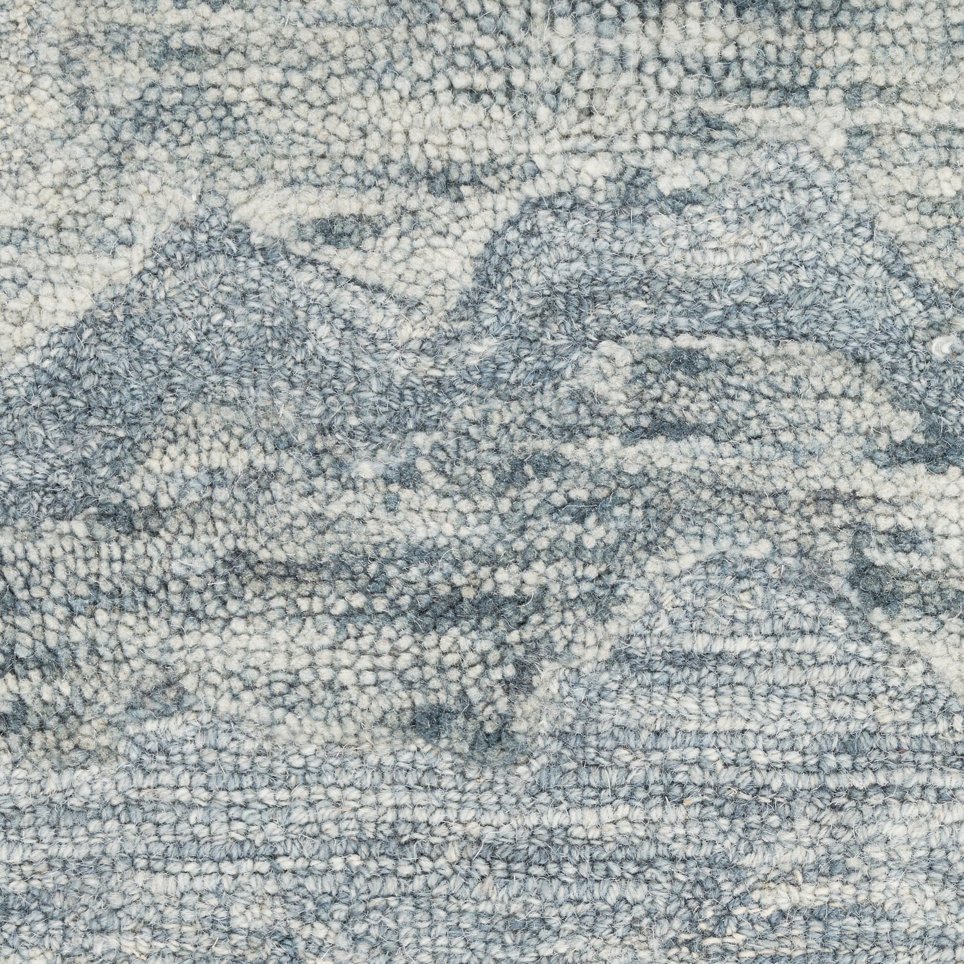 Blue-gray textured rug with ivory mountain pattern; soft loop-pile for cozy living spaces.
