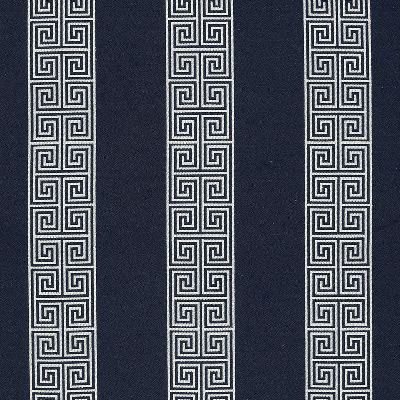 Navy fabric with three vertical white Greek-key meander stripes, geometric upholstery textile.