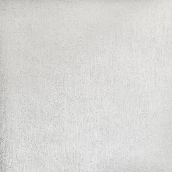 Close-up of a white textured wallcovering with subtle grain and shadows.
