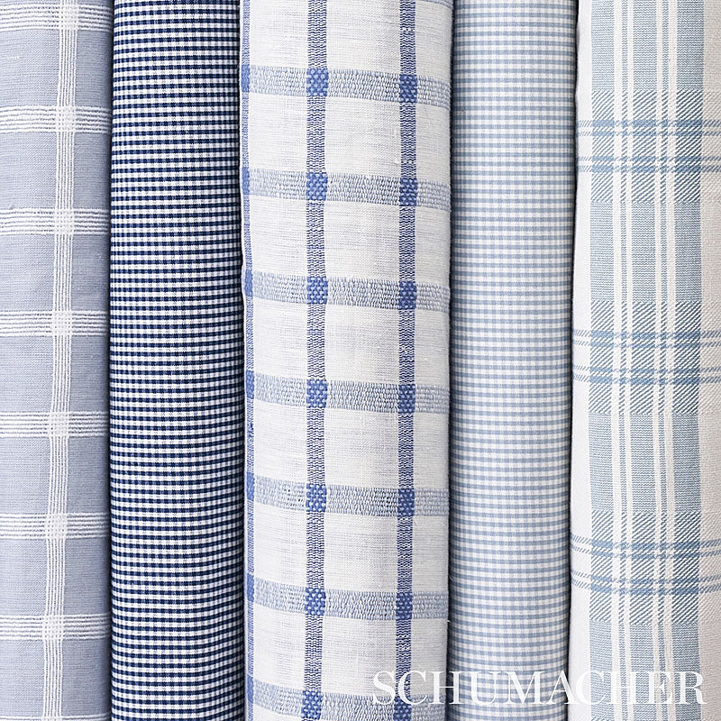 Rolled navy and white cotton check patterned woven fabrics; suitable for apparel or home decor.