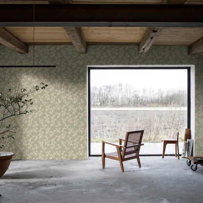 Industrial living space with pale green leaf-pattern wallpaper, exposed beams, and two wooden chairs by a doorway to a field.