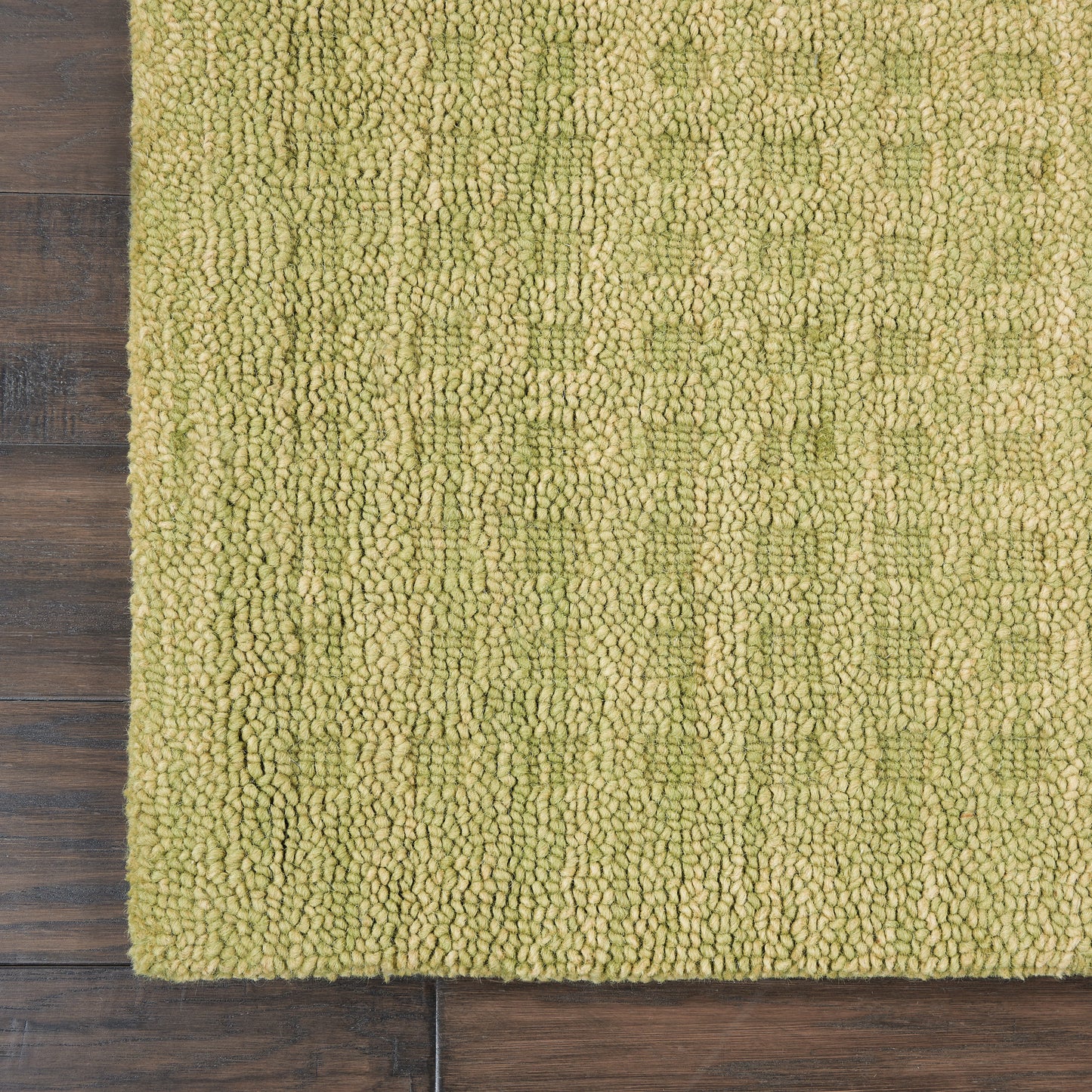 Olive-green loop-pile rug with dense shaggy texture on wooden floor; modern, rectangular, soft underfoot.