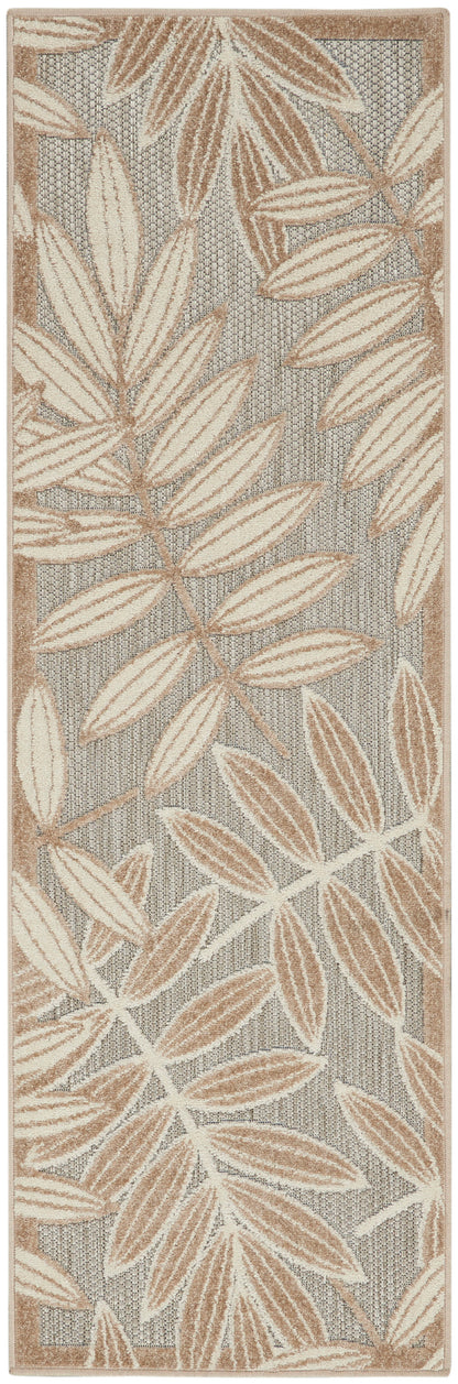 Long runner rug with tan and beige palm-leaf motifs on a gray woven backdrop.