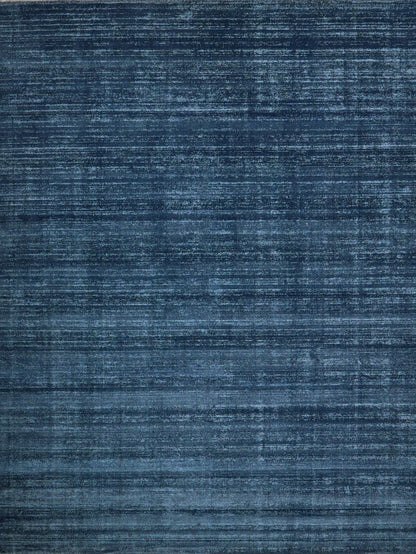 Blue distressed woven rug with subtle horizontal stripes and textured surface.