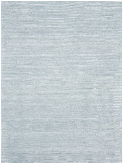 Light blue-gray rug with soft brushed texture and subtle horizontal streaks.