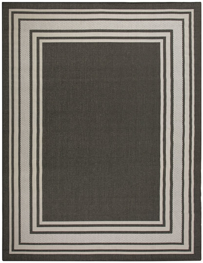 Rectangular dark charcoal woven rug with multiple light-gray borders in a modern geometric concentric frame design.
