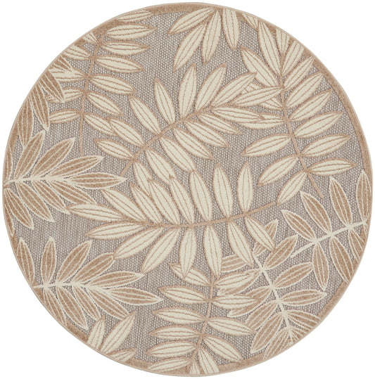 Round rug with taupe background and cream leaf pattern, textured linen-like surface.