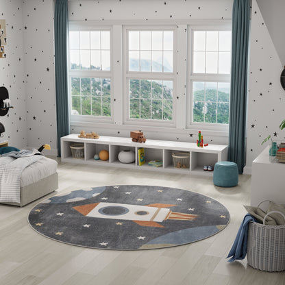 Round gray-blue rocket rug with stars in a bright kids' room; white cubby storage, starry walls, blue curtains.