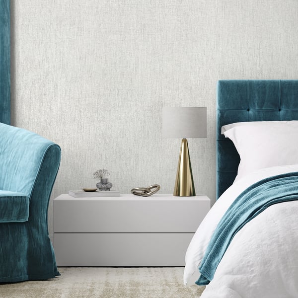 Teal wallpaper with a subtle pattern on the wall.