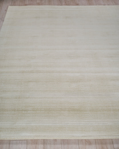 Cream beige rectangular rug with subtle horizontal stripes and soft texture on a light wooden floor.