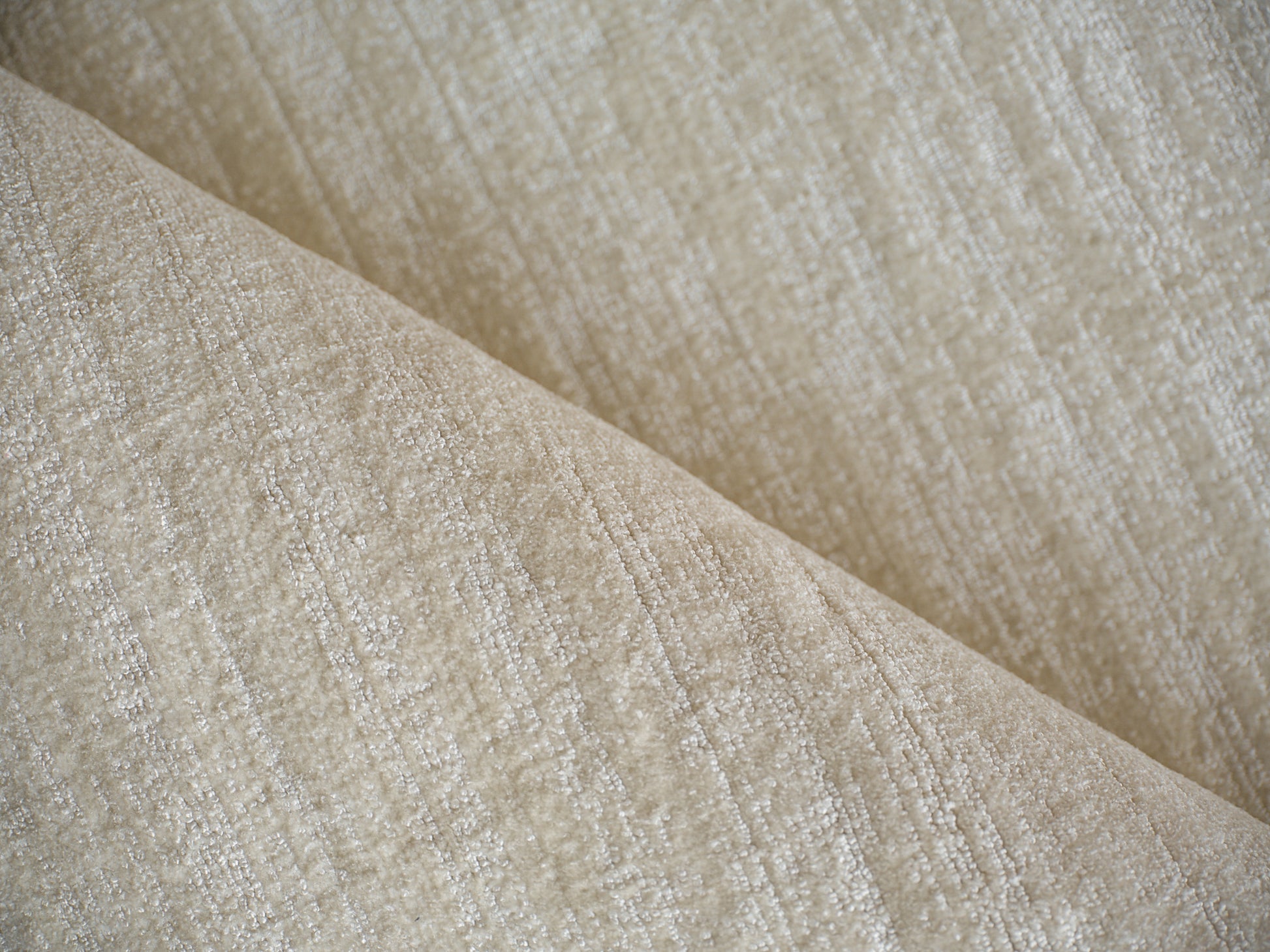Beige textured woven rug with subtle sheen; hand loomed indoor rug, 6' x 9'.