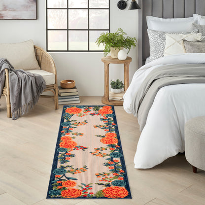 Long floral outdoor runner rug with orange roses and a teal border.
