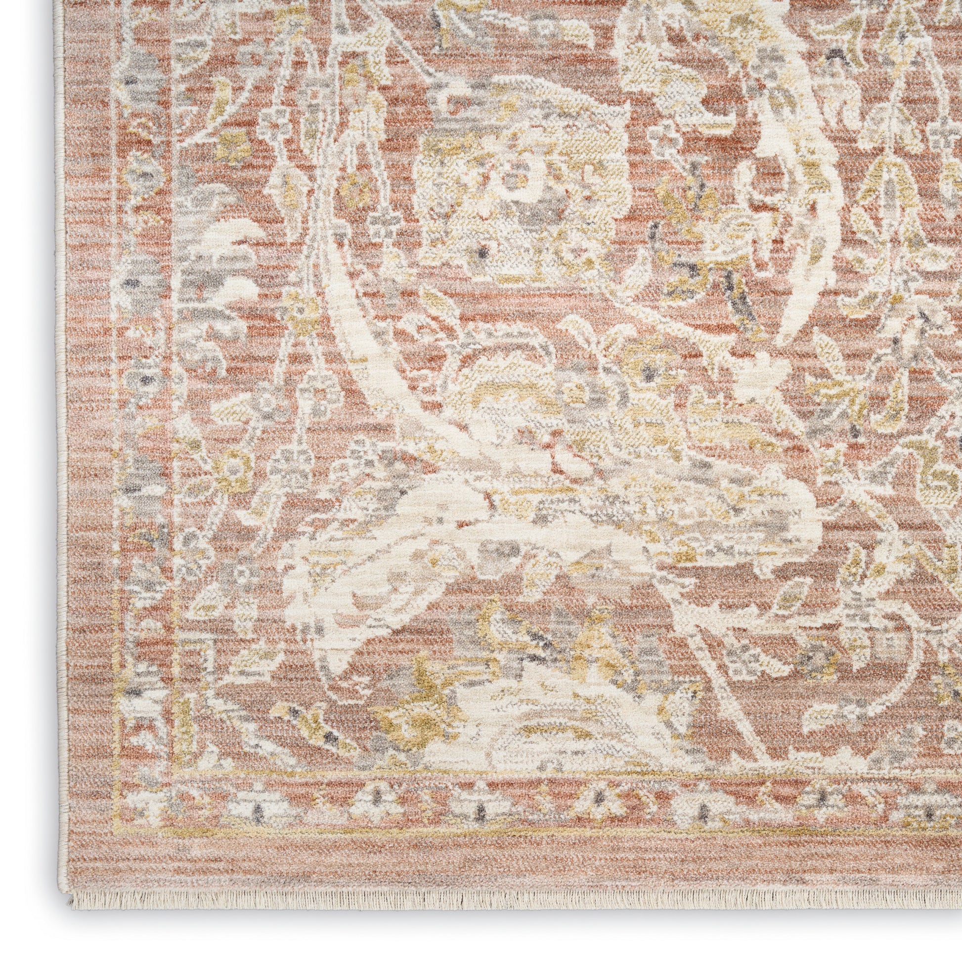 Distressed pink and ivory Persian-style area rug with floral medallion border, rectangular shape and fringe edge.