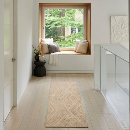 Bright minimalist hallway with wood-framed window seat, beige runner rug, cushions, plant on a black side table, glass railing.