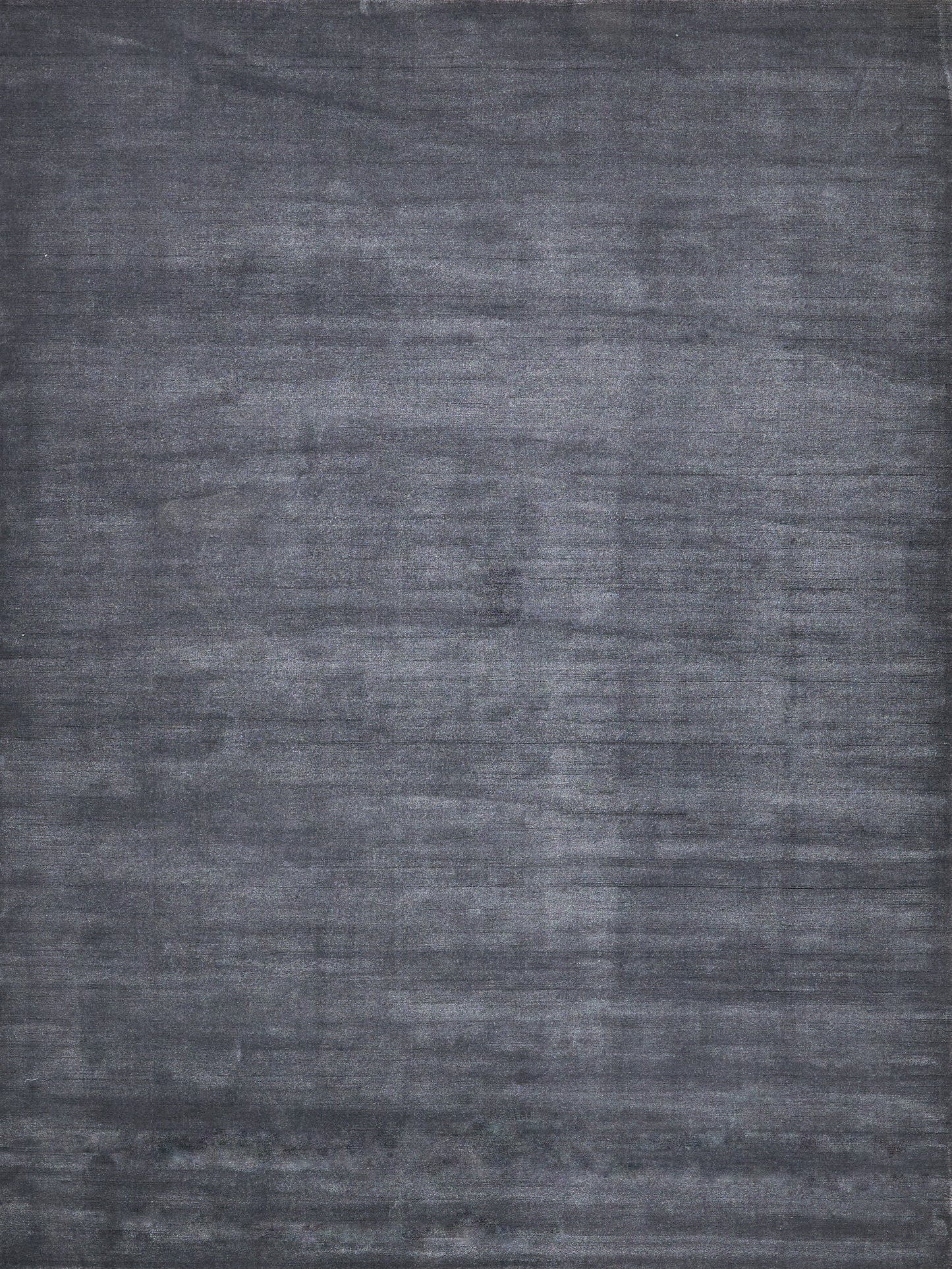 Charcoal gray textured rug with brushed, washed finish for modern & versatile decor.