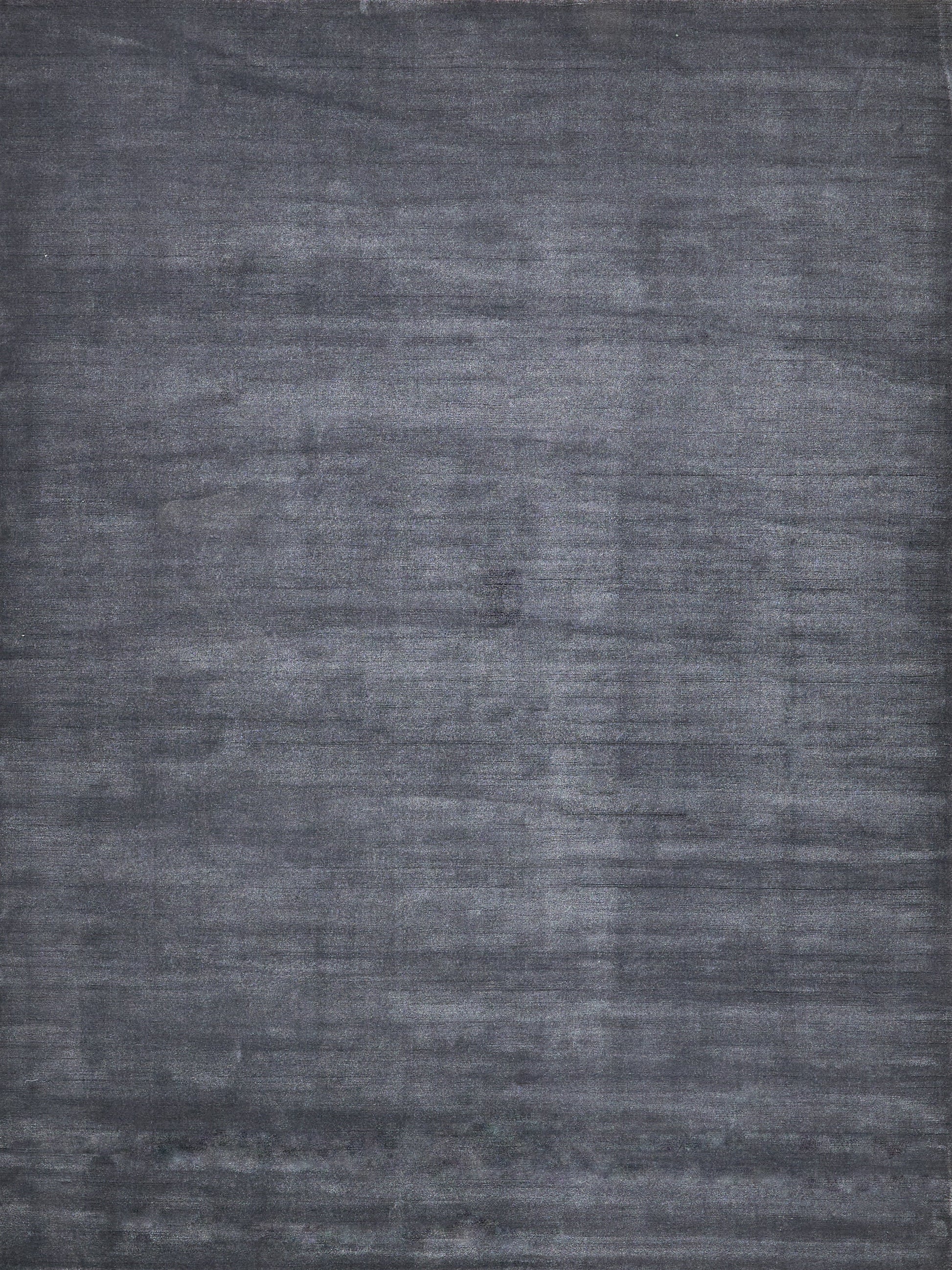 Charcoal gray textured rug with brushed, washed finish for modern & versatile decor.