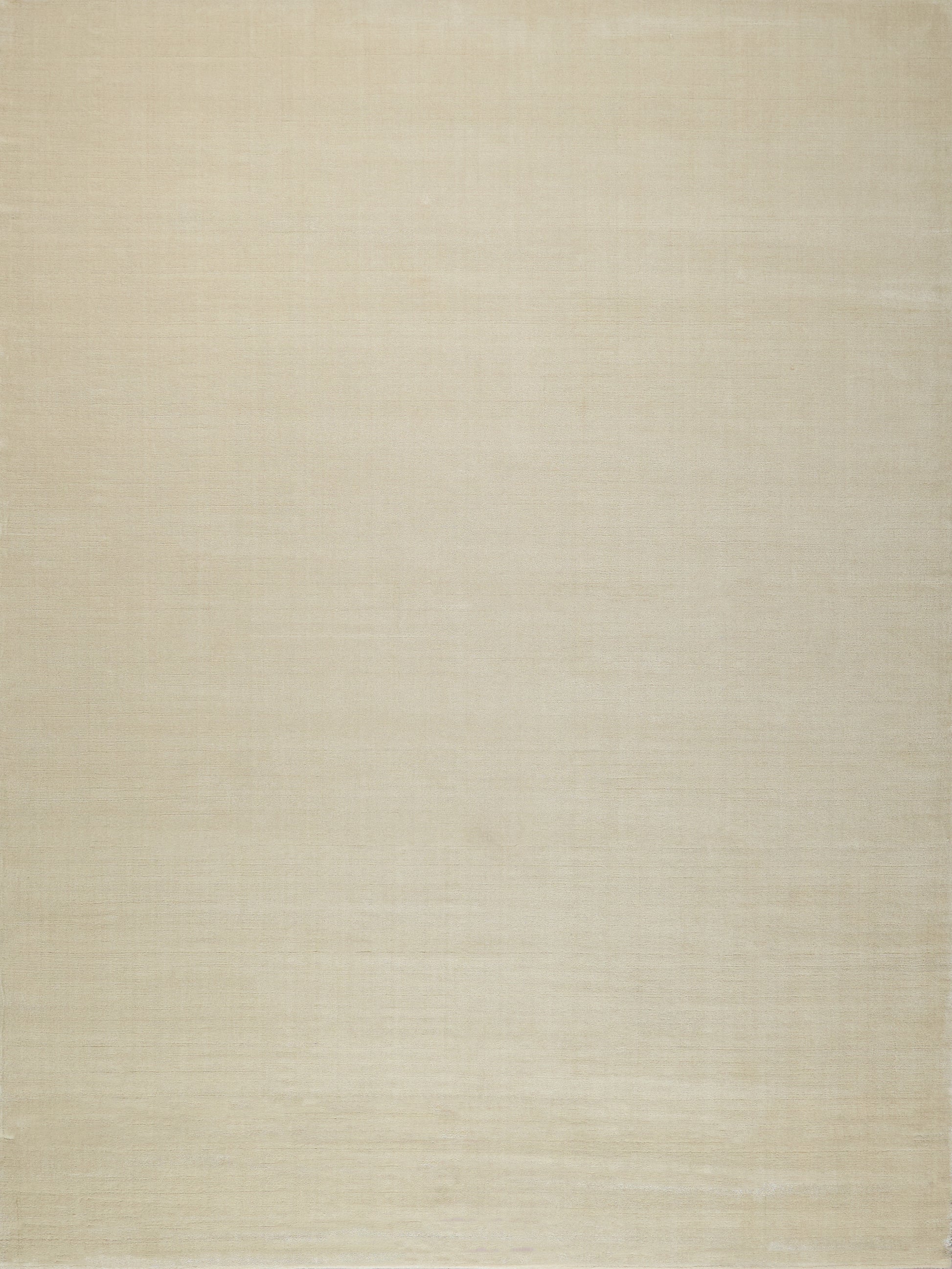 Beige hand-loomed rug with a subtle woven texture; indoor use.