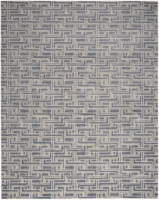 Blue and cream woven rug with a repeated interlocking meander pattern.