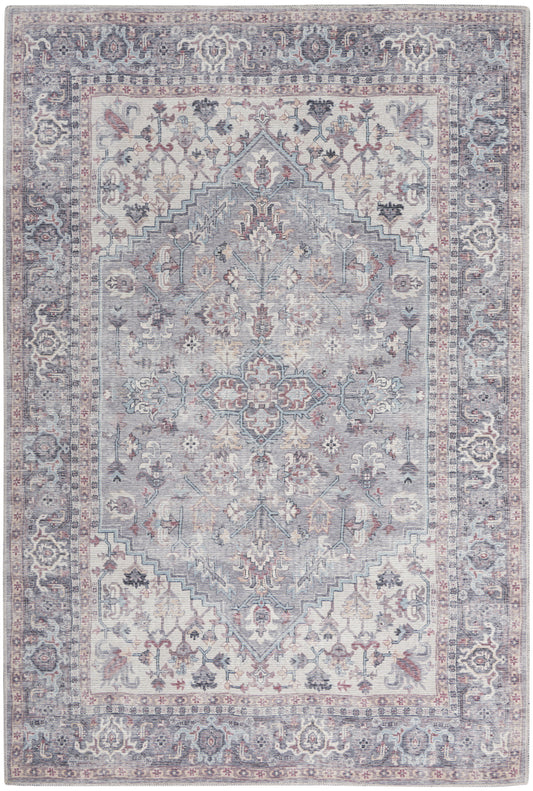 Pastel blue-gray oriental rug with ivory-pink accents, central stepped medallion, floral vines and ornate border.