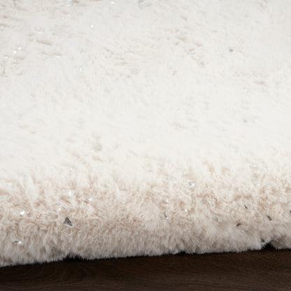 Creamy white plush shag rug with a thick pile, laid on dark wooden floor.