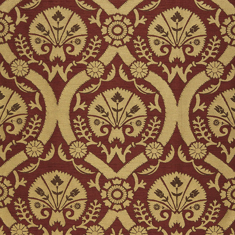 Gold damask pattern on burgundy fabric featuring floral medallions and scrolling foliage.