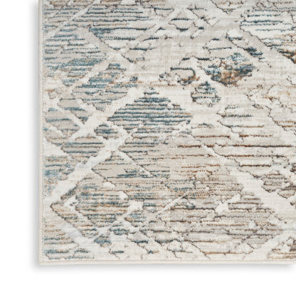 Rectangular distressed rug with cream, blue and tan tones; modern diamond pattern, soft tufted look.