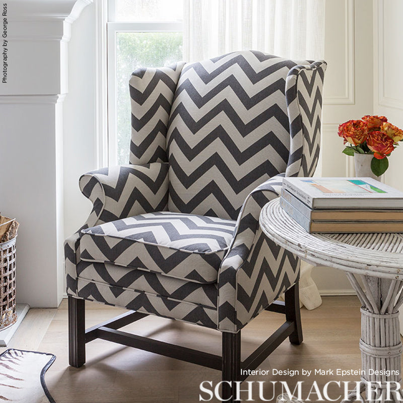 Grey & white chevron fabric armchair with dark wood legs, wingback style, cozy living-room seating.