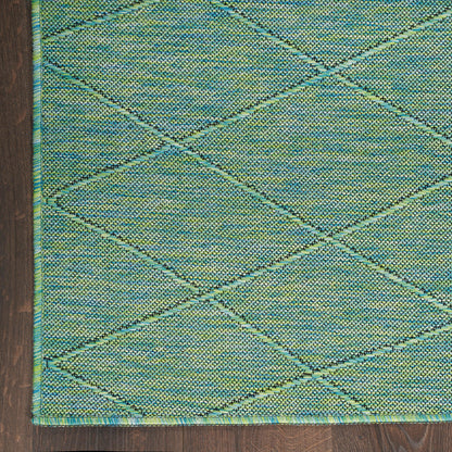 Teal and lime flat-weave rug with a diamond lattice pattern and blue-green border on dark wood floor.