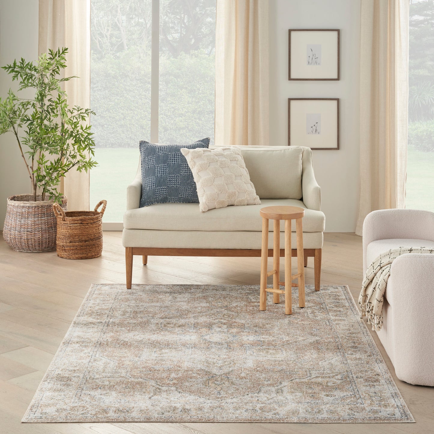 Beige vintage 4' x 6' rug with a blue-gray pattern on a light wood floor in a sunlit Scandinavian-style living room.