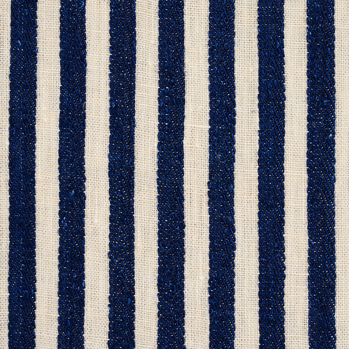 Vertical navy blue woven stripes on natural beige linen fabric; textured upholstery material.