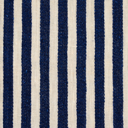 Vertical navy blue woven stripes on natural beige linen fabric; textured upholstery material.