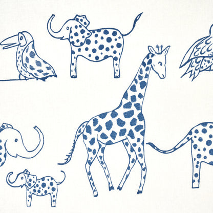 Blue ink animal sketch pattern featuring giraffes, elephants & a bird on cream textile background.