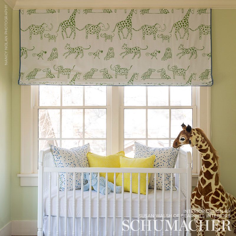 Green woven leaf-pattern fabric for a roman shade.