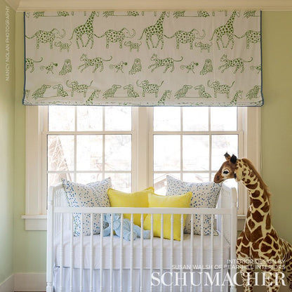 Green woven leaf-pattern fabric for a roman shade.