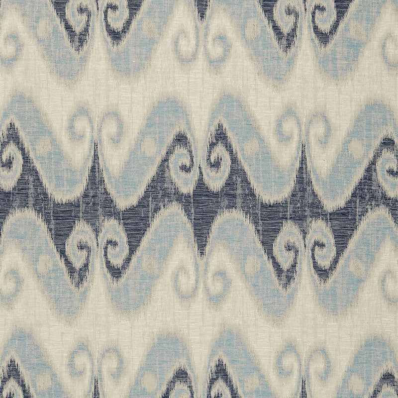 Ikat-inspired fabric featuring pale blue and navy wavy chevron on ivory background with a textured textile look.