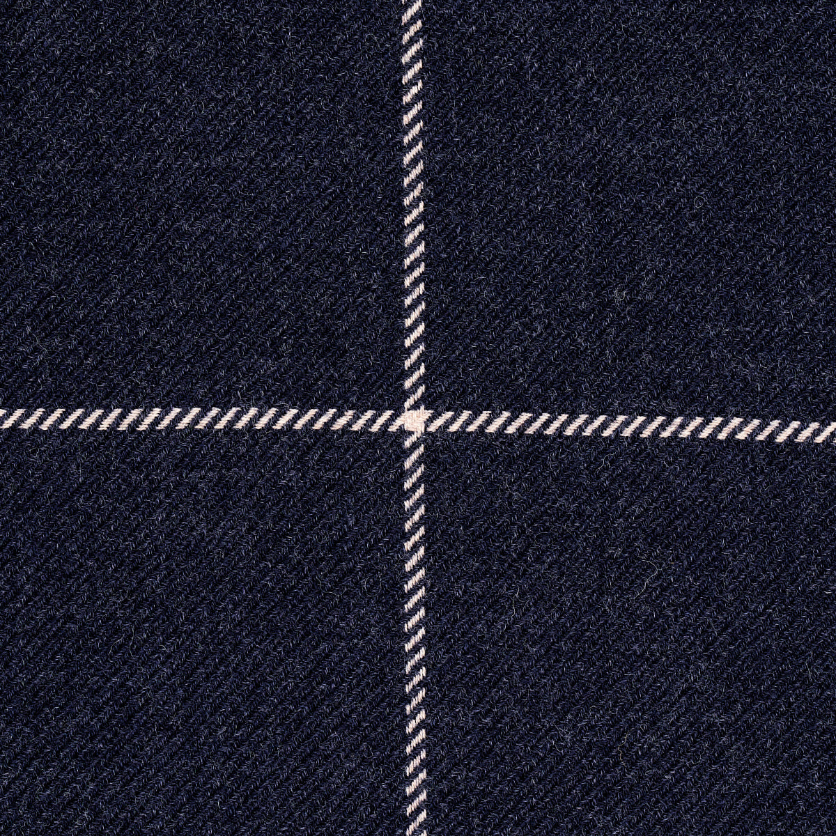 Close-up of navy wool plaid fabric with thin white windowpane lines in a woven pattern.